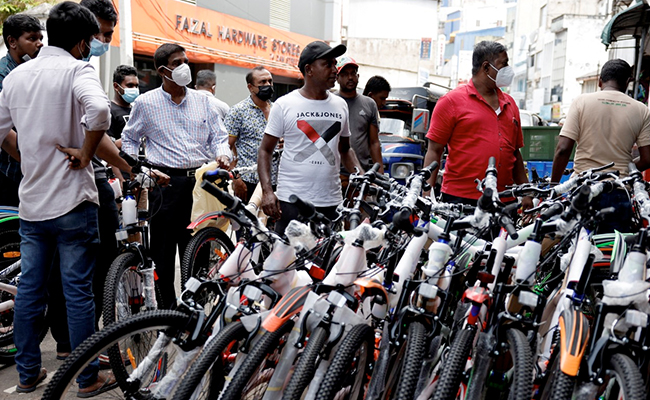 Sri Lankans Turn To Bicycles As Hundreds Line Up Outside Petrol Pumps