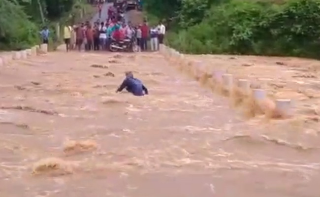 Video: Man Washed Away While Crossing Flooded Road In Andhra Pradesh