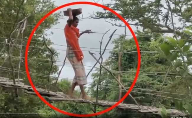 जान जोखिम में डालकर नदी के ऊपर लकड़ी के बने टूटे पुल से गुजर रहे लोग, दुर्घटना कभी भी हो सकती है