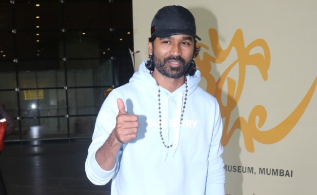 Ahead Of <i>The Gray Man</i> Mumbai Premiere, Dhanush And Joe Russo Pictured At The Airport