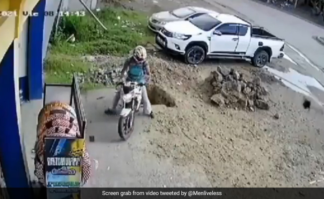 Caught On Camera: Man Accidentally Falls Into Pit While Reversing Bike