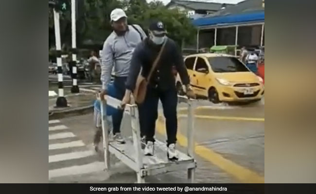 Man Helps People Cross Flooded Road For A Fee, Anand Mahindra Is Impressed