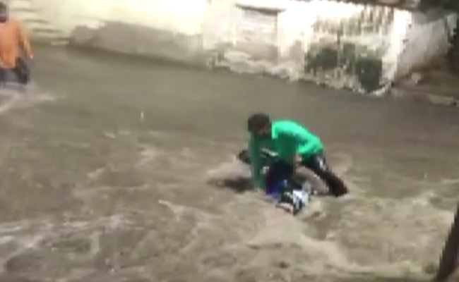 Watch: Biker Being Washed Away In Floodwater, Rescued In Hyderabad