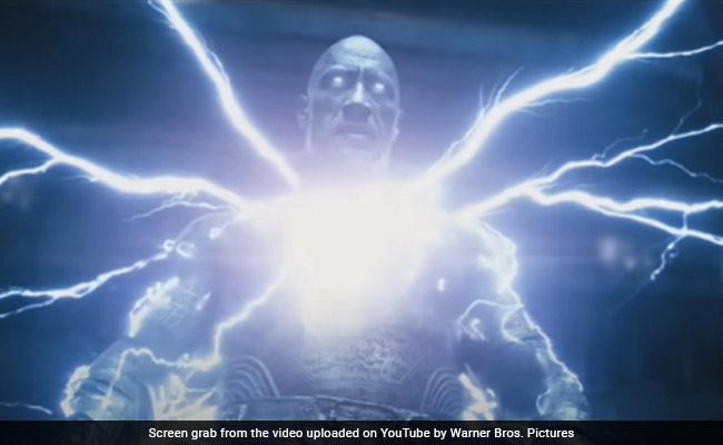 <i>Black Adam </i> Review:  Dwayne Johnson's Immense Star Power Does The Heavy Lifting