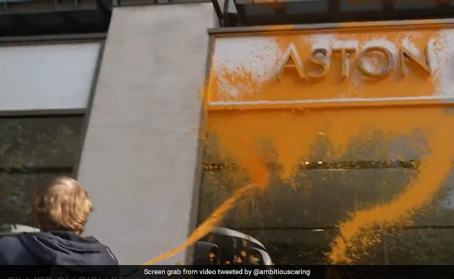 On Camera, UK Activists Spray Paint On Aston Martin Showroom In London