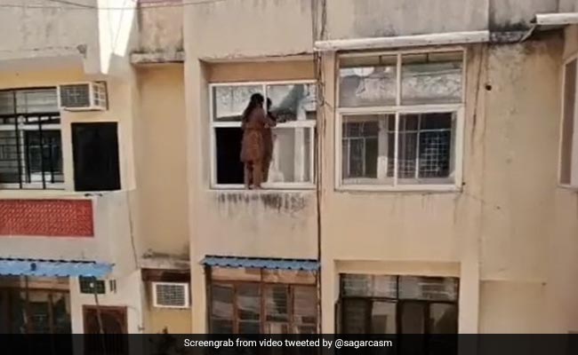Video: Woman's Daredevil Window-Cleaning Act Stuns Internet