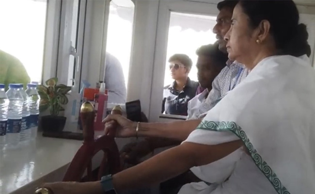 Watch: Mamata Banerjee Plays 'Helmsman', Steers Boat During Official Visit