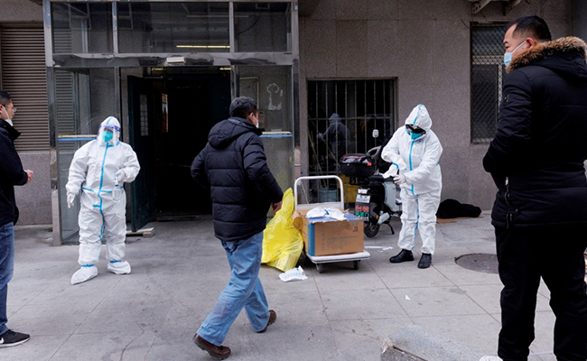 Despite New Covid Cases, Some Chinese Cities Reopen Shops, Scale Back Testing