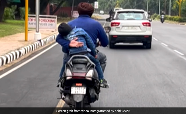 Watch: Man Holding His Child From Falling Off A Moving Scooter Moves The Internet