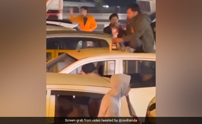 Viral Video: Man Drinks Alcohol On Car's Roof Amid Traffic Jam In Gurugram