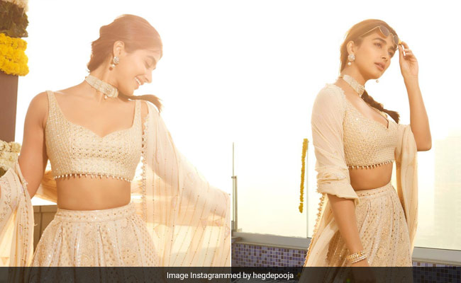 The Warm Golden Hour Sun Plays Supporting Role To Pooja Hegde's Ivory <i>Lehenga</i>
