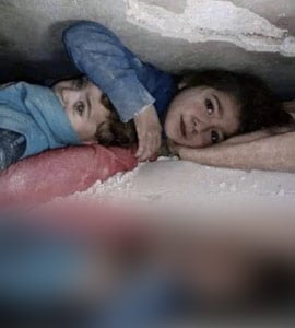 Moving Photo Shows 7-Year-Old Girl Shielding Brother Under Rubble In Syria