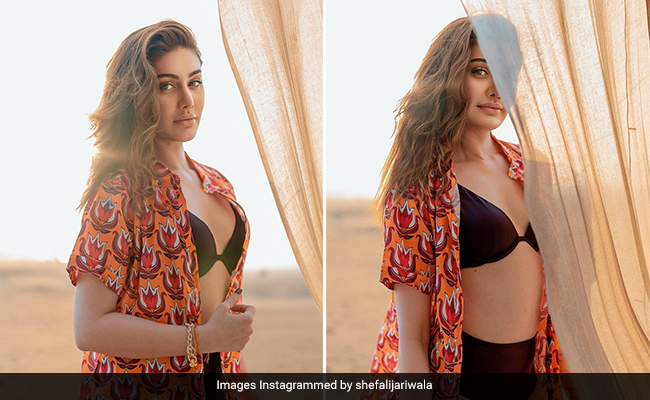 "Sky Above, Sand Below" And Right Here, Shefali Jariwala In A Black Swimsuit With A Printed Shirt