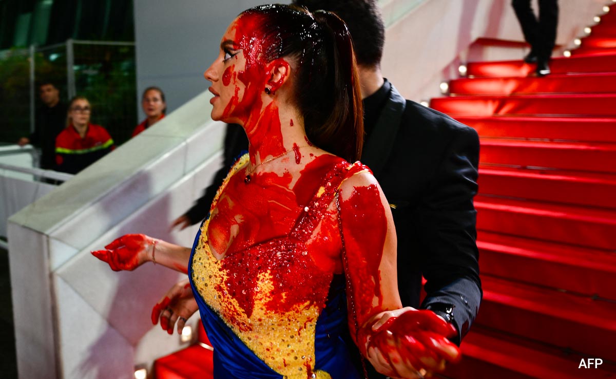 Protester Dressed In Ukrainian Colours Covers Herself In Fake Blood On Cannes Red Carpet
