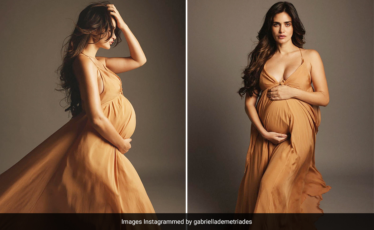 Mom-To-Be Gabriella Demetriades Cradles Her Baby Bump In A Flowing Sleeveless Orange Gown
