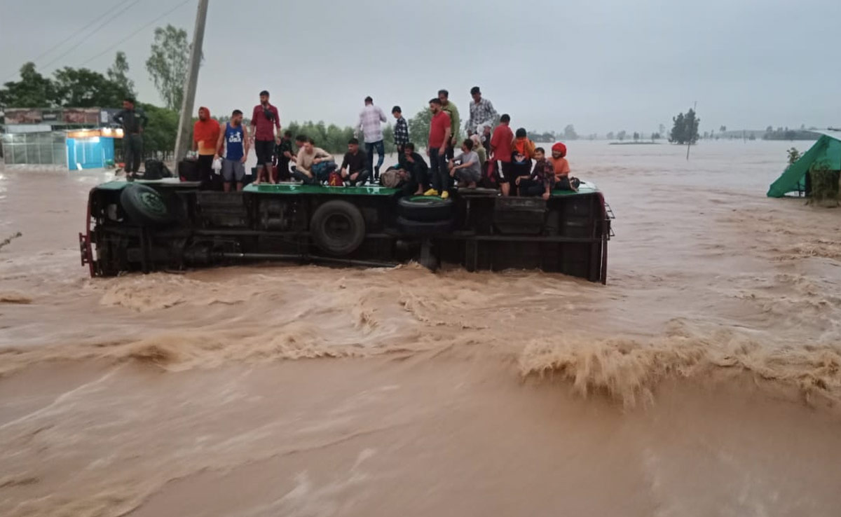 Video: Bus Tips Over On Flooded Road, Rope, Crane Used To Rescue 27