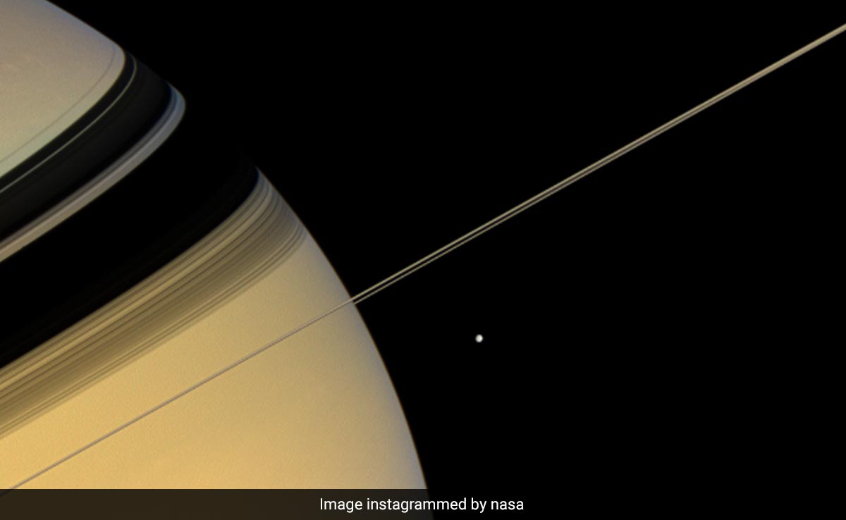 NASA's Cassini Spacecraft Captures Astonishing Pic Of Saturn And Its Moon