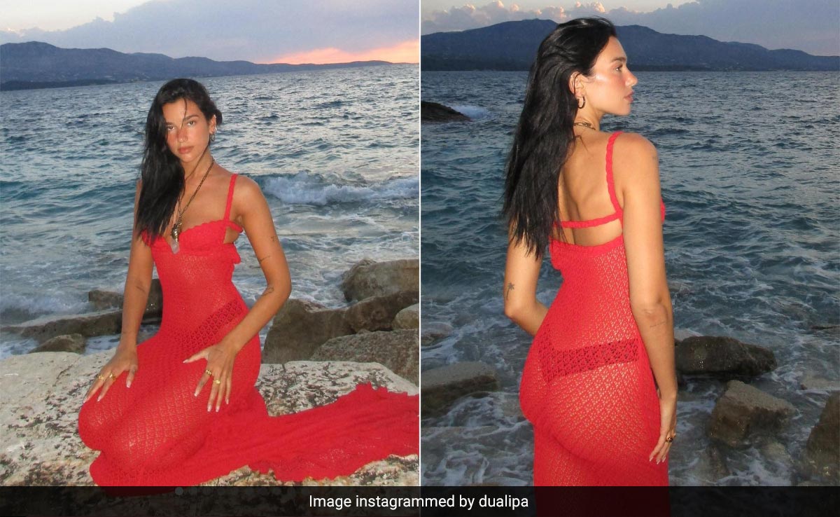 Dua Lipa Takes Her Title Of Mermaid <i>Barbie</i> Very Seriously In A Fiery Red Sheer Crochet Dress By The Sea
