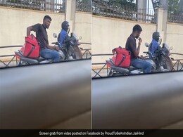 ट्रैफिक सिग्नल पर रुकते ही फूड डिलीवरी बैग से खाना निकालकर खा रहा था Delivery Boy, वायरल Video देख भड़के लोग ट्रैफिक सिग्नल पर रुकते ही फूड डिलीवरी बैग से खाना निकालकर खा रहा था Delivery Boy, वायरल Video देख भड़के लोग