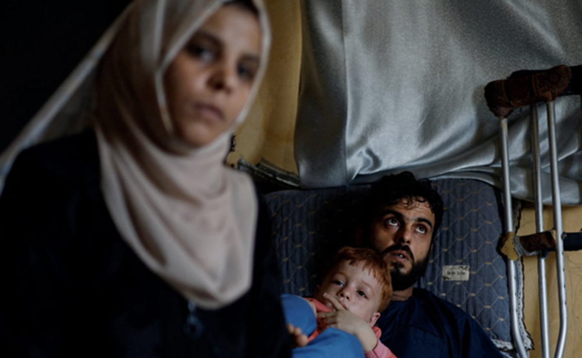 Inas Abu Maamar, 36, sits next to her brother Ramez, the father of Saly, as her nephew Ahmed. Inas Abu Maamar, 36, sits next to her brother Ramez, the father of Saly, as her nephew Ahmed.