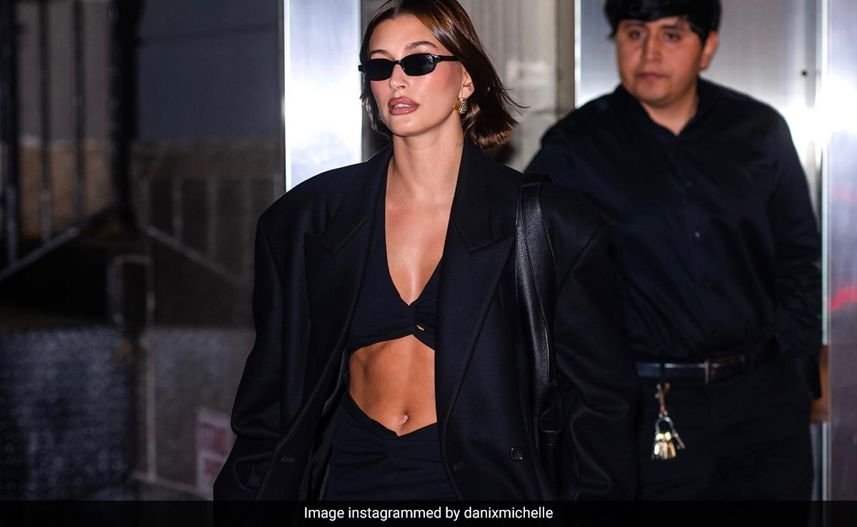Hailey Bieber Didn't Have To Go So Hard In A Black Crop Top, Skirt And A Trench Coat, But Boy She Did