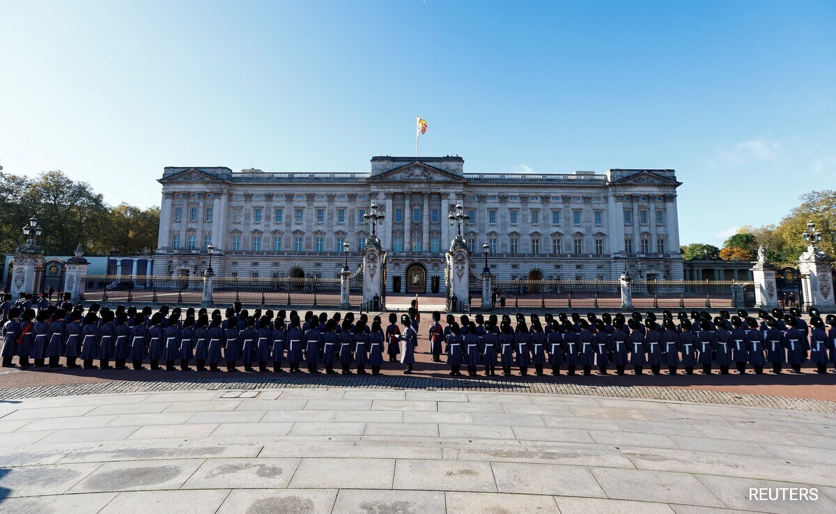 Members of the military march aline in front of Buckingham Palace, on the day of the State Opening of Parliament.