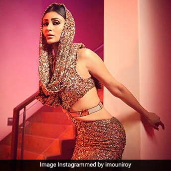Mouni Roy's Golden Hooded Cutout Gown With A Belt Sparkles Like A Sky Lit Up With Fireworks Mouni Roy's Golden Hooded Cutout Gown With A Belt Sparkles Like A Sky Lit Up With Fireworks