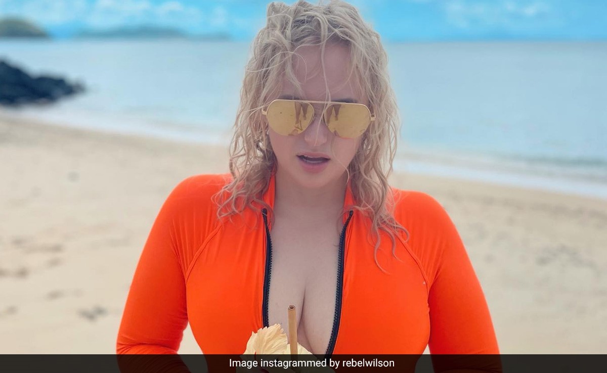 Rebel Wilson's Fiji Beach Holiday Is Spent Rather Stylishly In Bright Orange Swim Look