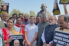 Suspended MPs Protest Near Gandhi Statue Outside Parliament Building Suspended MPs Protest Near Gandhi Statue Outside Parliament Building