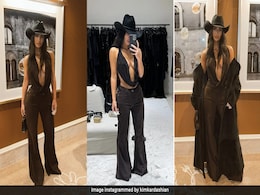 Kim Kardashian Takes Her Cowgirl Duties In A Cowl Top, Trousers And Hat Very Seriously Kim Kardashian Takes Her Cowgirl Duties In A Cowl Top, Trousers And Hat Very Seriously