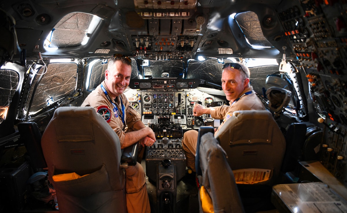 Andy Barry (L) and Greg Slover, pilots of the NASAs DC-8 airborne science laboratory, pose for a photo inside the cockpit of the aircraft