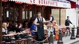 Waiters In Paris Race In The City While Balancing Tray With Coffee And Croissant