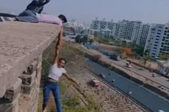Pune Woman Hangs From Building Holding Man's Hand. All For A Reel Pune Woman Hangs From Building Holding Man's Hand. All For A Reel