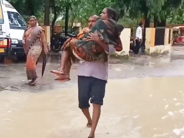 Video: Man Carries Wife In Arms Across A Flooded Street To Get To UP Hospital