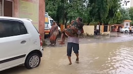 Video: Man Carries Wife In Arms Across A Flooded Street To Get To UP Hospital