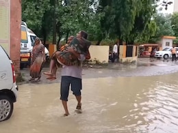 Video: Man Carries Wife In Arms Across A Flooded Street To Get To UP Hospital