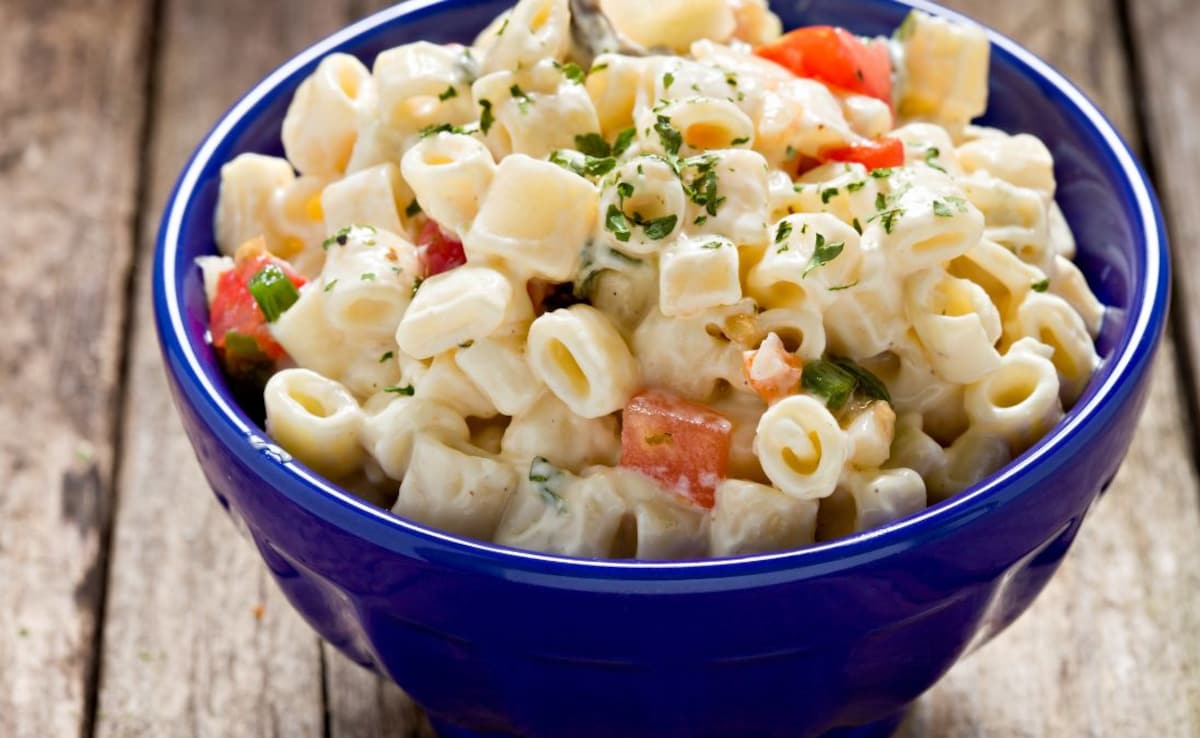 This salad features a delightful mix of pasta and macaroni.