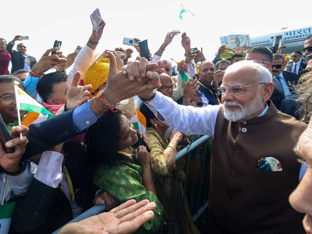 PM Modi Greets Indians Outside US Hotel, Signs Posters