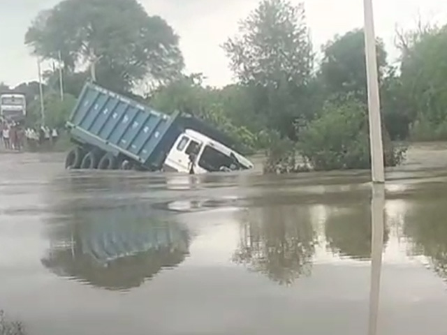 Dumper Truck Sinks As Driver Tries To Take It Across Flooded Bridge In UP