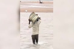 Odisha Couple Battles Rising Seas To Reach Home Amid Cyclone Dana's Fury Odisha Couple Battles Rising Seas To Reach Home Amid Cyclone Dana's Fury