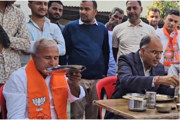 बीजेपी कार्यकर्ता के घर खाना खाते मंत्री और विधायक.