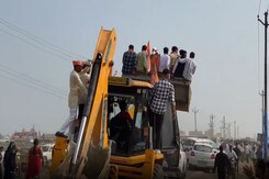 UP CM Yogi Adityanath's Supporters Attend His Public Rally On A Bulldozer In Mainpuri UP CM Yogi Adityanath's Supporters Attend His Public Rally On A Bulldozer In Mainpuri