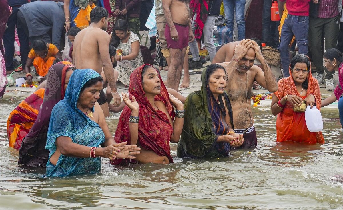 Devotees take a holy dip at the Sangam on the Makar Sankranti festival 