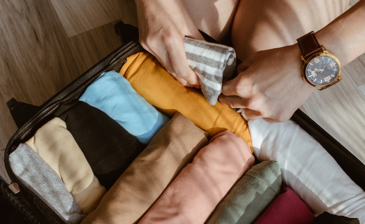Roll your clothes to keep it neat. Photo: iStock Roll your clothes to keep it neat. Photo: iStock
