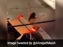 Video Shows Naked Iranian Woman Jumping On Police Car In Bold Protest