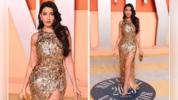 It's Hard To Look Away From Nora Fatehi In A Thigh-High Slit Golden Oscar De La Renta Gown