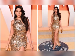 It's Hard To Look Away From Nora Fatehi In A Thigh-High Slit Golden Oscar De La Renta Gown It's Hard To Look Away From Nora Fatehi In A Thigh-High Slit Golden Oscar De La Renta Gown