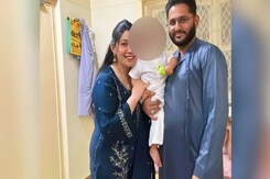 In Queue To Give Samples To Identify Crash Victims, 8-Month-Old In Uncle's Lap In Queue To Give Samples To Identify Crash Victims, 8-Month-Old In Uncle's Lap