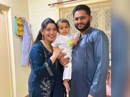 In Queue To Give Samples To Identify Crash Victims, 8-Month-Old In Uncle's Lap In Queue To Give Samples To Identify Crash Victims, 8-Month-Old In Uncle's Lap