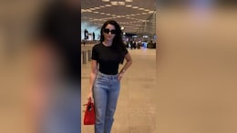 Nora Fatehi Serves Airport Fashion Goals In A Classic Black Tee And Blue Jeans